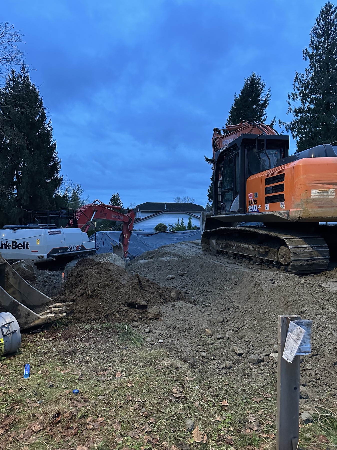 An excavator working on a residential lot