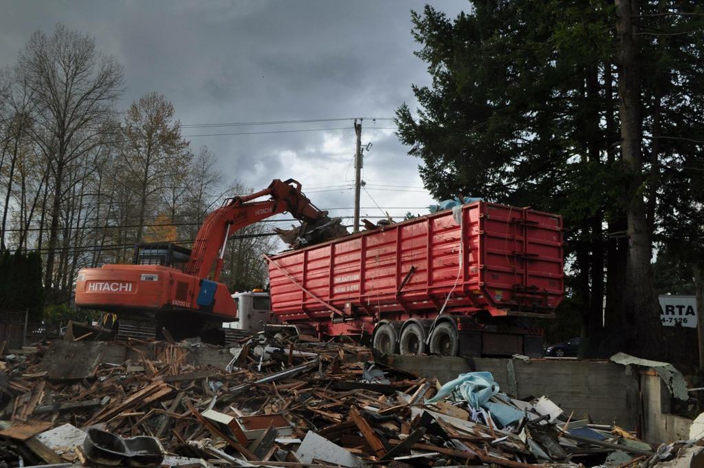 An excavator loading demolition debris