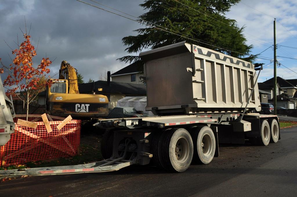 A dump truck and excavator on a job